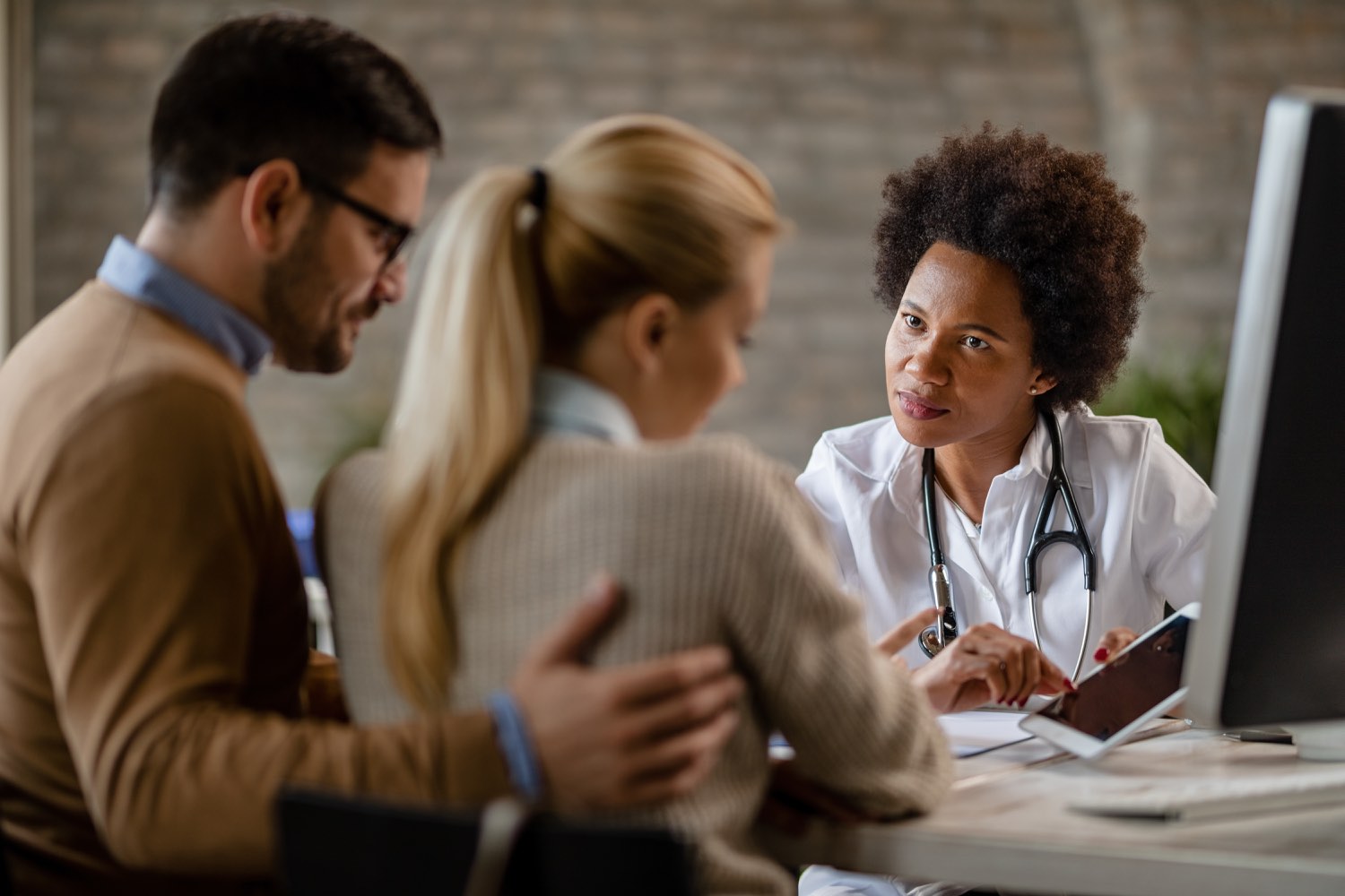 Doctor reviewing records during a medication-safety conversation.