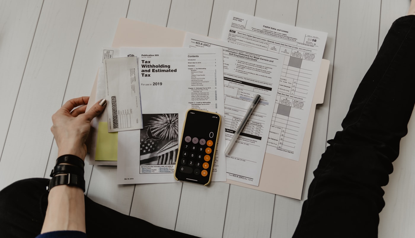 Calculator and paperwork used for medical cost planning.