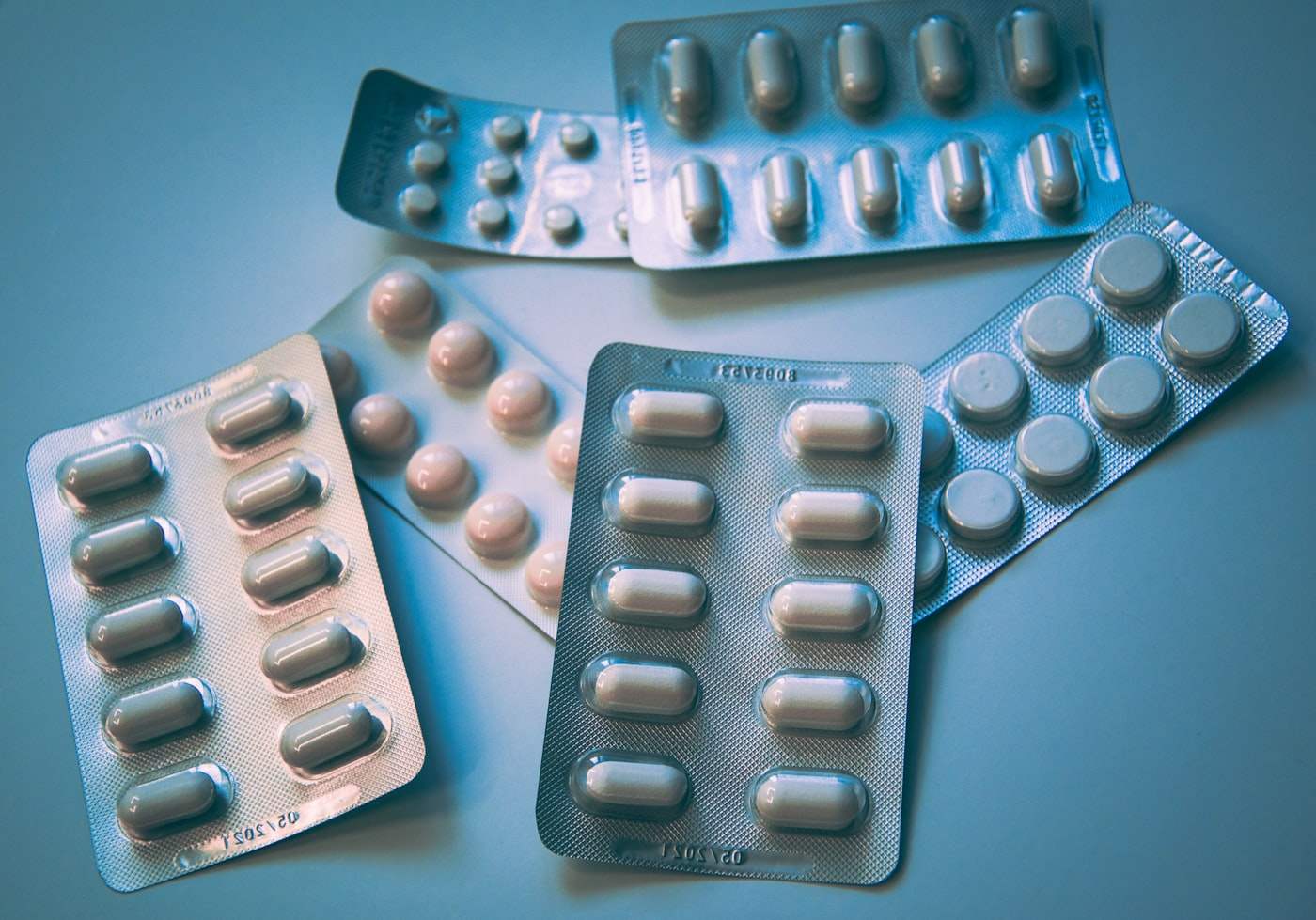 Medication blister packs on a clinical surface.