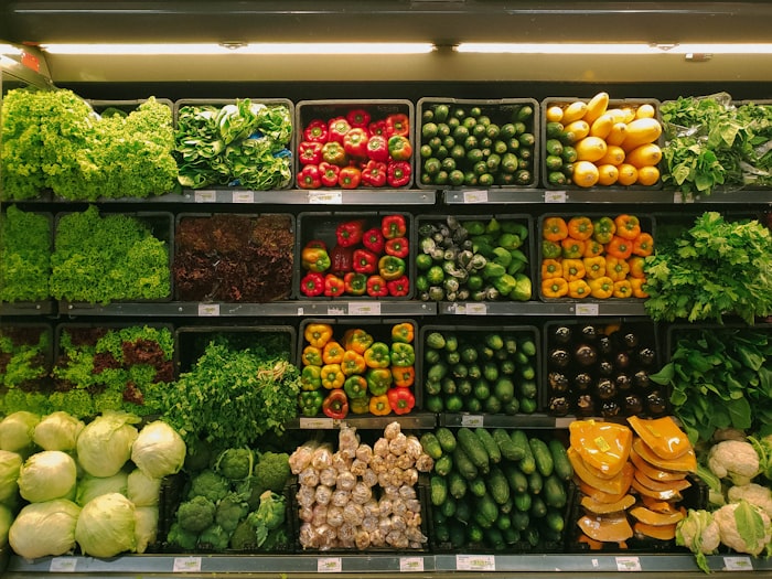 Stocked produce shelves in a grocery store.