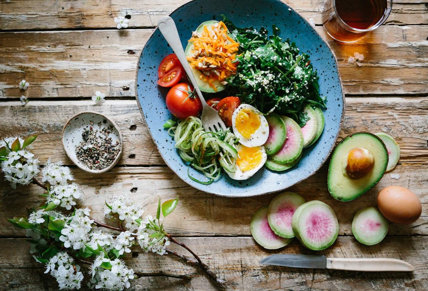 Protein-forward meal bowls on a wooden table.