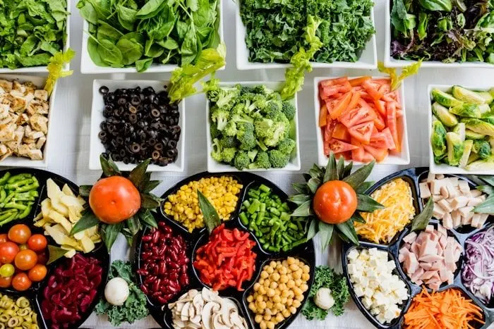 Chopped vegetables portioned into prep trays.